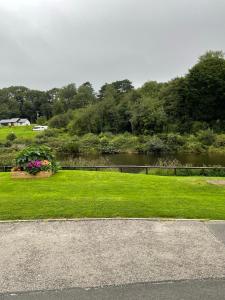 a view of a park with a lake and a yard at Runaway Cottage, Whitby in Whitby