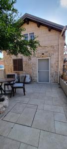 a patio with a building with a garage at Cottage in Center of Historic Zichron Yaakov in Zikhron Ya‘aqov