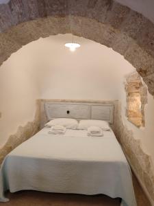 Un ou plusieurs lits dans un hébergement de l'établissement Luxury Trulli sabotino