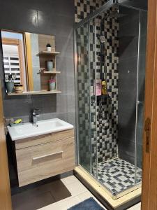 a bathroom with a shower and a sink at Maison Bleu in Mansouria