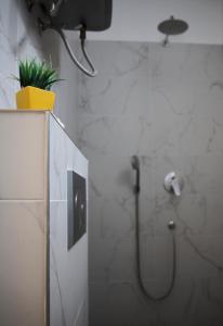 a bathroom with a shower with a plant in it at Podroom Apartments in Ljubljana