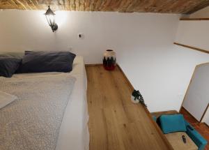 a bedroom with a bed and a wooden floor at Podroom Apartments in Ljubljana