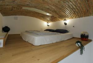 a bedroom with a bed with a brick ceiling at Podroom Apartments in Ljubljana