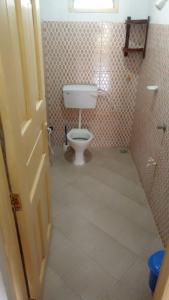 a bathroom with a white toilet in a room at Manama Suites Lamu in Lamu