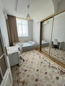 a room with two beds and a desk and a window at Flat in Chisinau in Chişinău