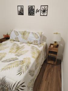 a bedroom with a bed and a night stand with a lamp at Villa Bonita praia in Palhoça +27 photos