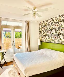 a bedroom with a bed and a green wall at Ruim comfortabel appartement centrum Breda MET restaurant! in Breda