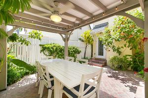 a white table and chairs on a patio at Coronado Seaside Cottage in San Diego