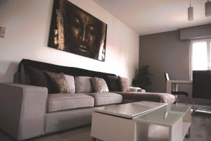 a living room with a couch and a table at Calm and Cozy apartment Bivange in Livange