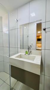 a white bathroom with a sink and a mirror at Hotel Pousada Kairos Manaira in João Pessoa +41 photos