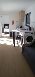 a kitchen with a table and a bed in a room at Rail Trail Retreat in Scottsdale