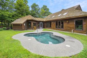 a house with a small pool in the yard at Highridge B16A Hotel Room Only, Delightful hotel room, sleeps 2 in Killington