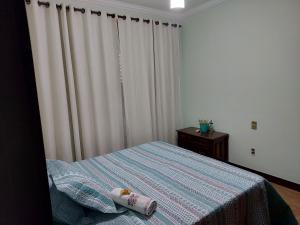 מיטה או מיטות בחדר ב-Espaço Aconchego