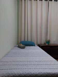 מיטה או מיטות בחדר ב-Espaço Aconchego