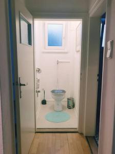 a bathroom with a toilet through a door at Ferienwohnung Sigmaringen in Sigmaringen