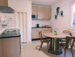 a kitchen with a table and a table and chairs at Ferienwohnung Sigmaringen in Sigmaringen