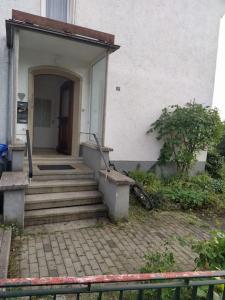 a house with a staircase leading to a door at Ferienwohnung Sigmaringen in Sigmaringen