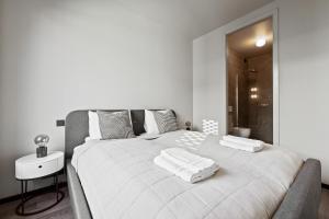 a bedroom with a large white bed with two towels on it at Cozy Lux 2BR & 2BA City Center with Free Parking in Reykjavík