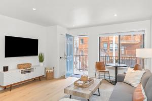 a living room with a couch and a tv at Boomerang 203 - A Telluride Retreat in Telluride