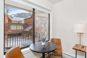 a room with a table and chairs and a large window at Boomerang 203 - A Telluride Retreat in Telluride