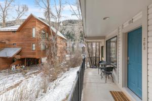 a house with a blue door on a balcony at Boomerang 203 - A Telluride Retreat in Telluride