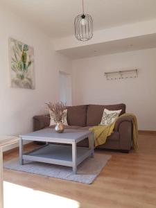 a living room with a couch and a coffee table at Piso- Huesca Capital - with elevator in Huesca