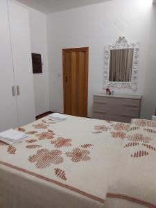 a bedroom with a large bed and a mirror at Casavacanze Vicolo Mentana in Foligno +6 photos