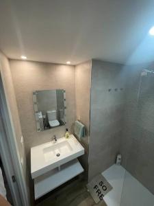 a bathroom with a sink and a shower at Apartment Montaña Clara & pool in Mogán +15 photos