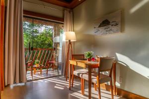 a dining room with a table and chairs and a balcony at Don Pascual - Hotel & Gastronomia in Rio de Janeiro