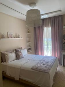 a bedroom with a large bed and a window at Cosy appartement in Bouznika +36 photos