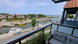 a balcony with a view of a marina with boats at PORT KRYNICA Apartamenty in Krynica Morska