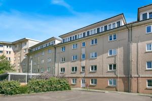 a large brick building with a lot of windows at Links Road Apartment ✪ Grampian Lettings Ltd in Aberdeen