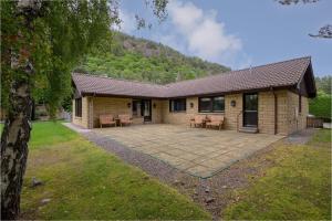 a house with a patio in front of it at Ballater Bungalow - 4 bed - Beautiful Garden in Ballater