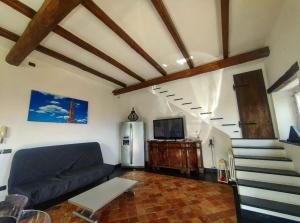 a living room with a couch and a refrigerator at Nacco Home in Genoa