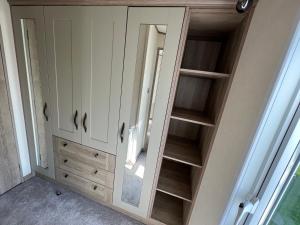 a wardrobe with a mirror in a room at Tarilana in Kent