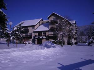 a building with snow on the ground in front of it at Appartement cosy à Autrans, 6 pers, 54m², balcon, proche pistes et commerces - FR-1-737-49 in Autrans