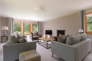 a living room with two couches and a fireplace at Ballater Bungalow - 4 bed - Beautiful Garden in Ballater