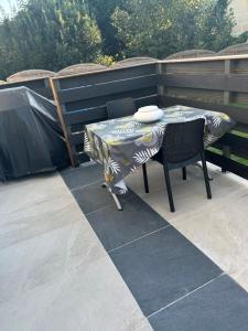 un tavolo e delle sedie seduti su un patio di Dépendance région bordelaise a Saint-Loubès