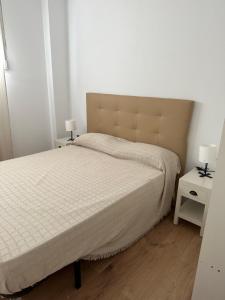 a bedroom with a large bed and two night stands at Apartamento Valencia 17 in Paiporta