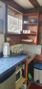 a kitchen with a sink and a counter top at REFUGIO CAMPESTRE A 7 MIN DE OSORNO in Osorno