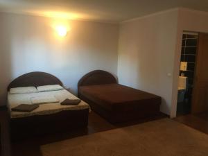 a small bedroom with a bed and a ottoman at Номер та Паркінг in Chernivtsi
