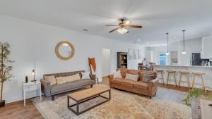 a living room with two couches and a kitchen at Eagle's Retreat - Close to GSU & Paulson Stadium in Statesboro