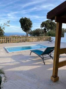 a swimming pool with a bench next to a wooden fence at Grand chalet d’été avec piscine in Bonifacio