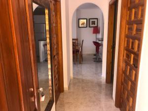 a hallway with an open door leading to a dining room at Paraíso in Cumbre del Sol