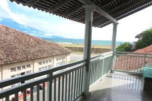 a balcony with a view of the ocean at Khalid's Guest House in Galle