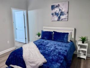 a bedroom with a blue bed with a blue comforter at Lake Norman Royal Retreat in Mooresville
