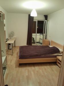 a bedroom with a bed and a desk and a window at VILLA AHNENERBE in Munich