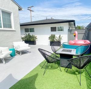 a backyard with a pool with a inflatable swan and chairs at Crown Point Home w/ Cowboy Pool 2 Blocks to Bay in San Diego
