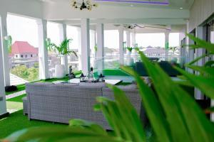 a living room with a couch and some plants at Gilpins Classic Penthouse in Lekki