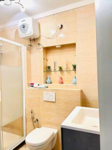 a small bathroom with a toilet and a sink at Gilpins Classic Penthouse in Lekki